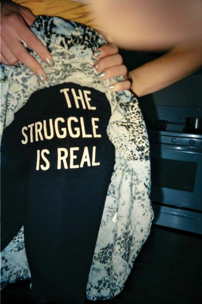 torso of a person in sweatpants that read "the struggle is real"