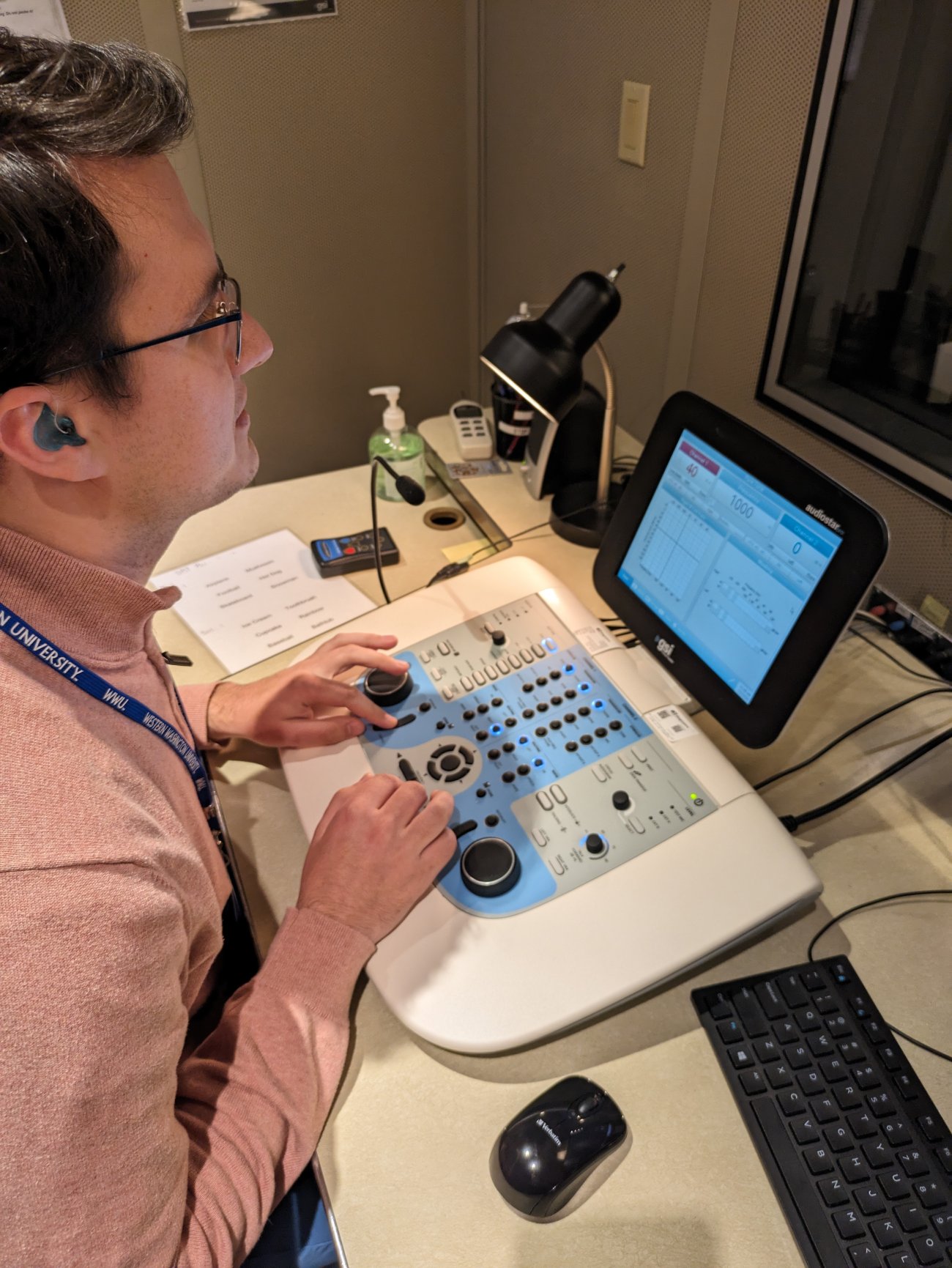 Audiologist sitting at audiometer