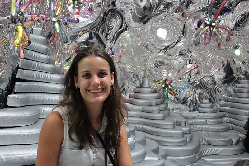 Virginia Dawson in front of a psychedelic silver sculpture