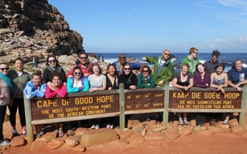 Large group of students gathered behind "Cape of Good Hope" sign