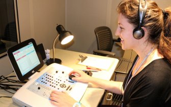 A woman works on a sound board
