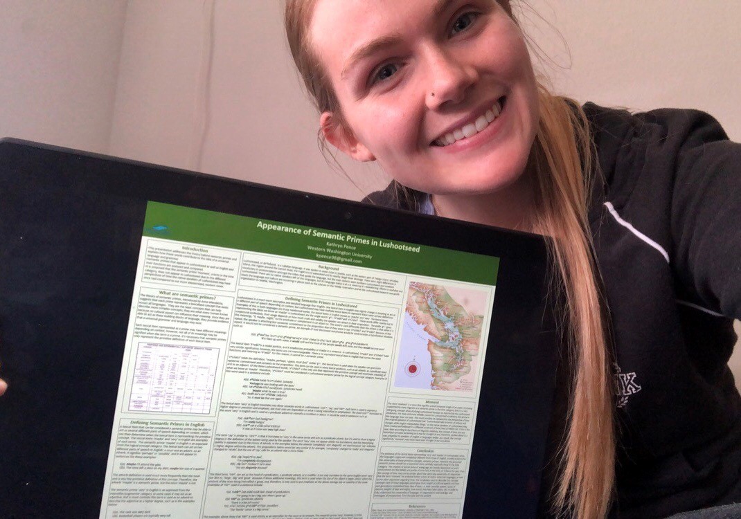 Kathryn Pence poses in front of an academic poster at a virtual academic conference.