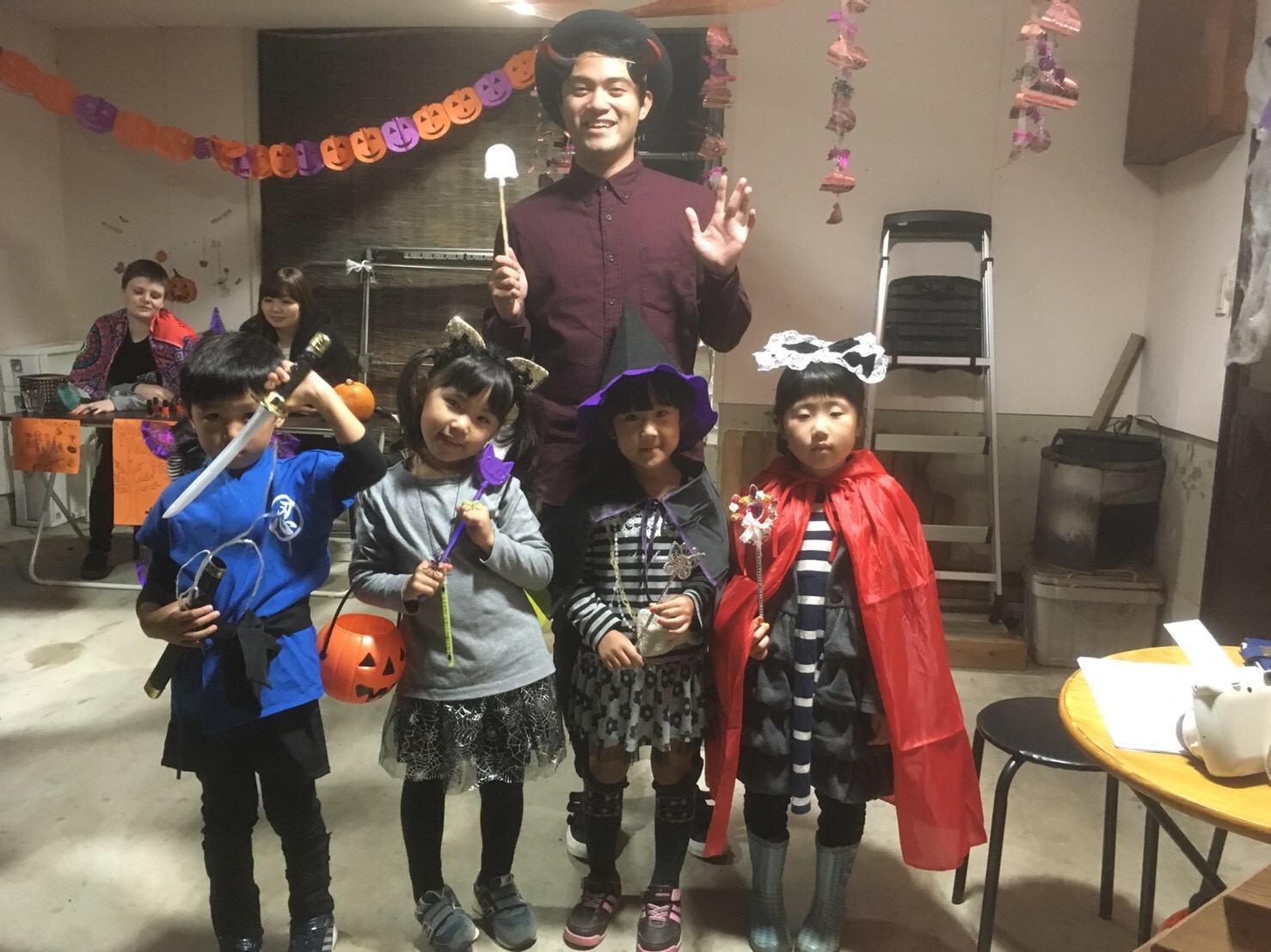 Six Japanese elementary students and preschoolers celebrating Halloween for the first time with help from Martinez, who volunteers at an English Conversation School in Japan.