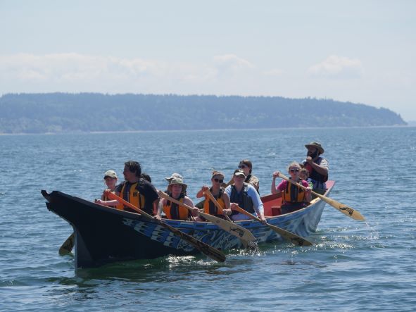 student participating in canoe journey 2022 summer field school