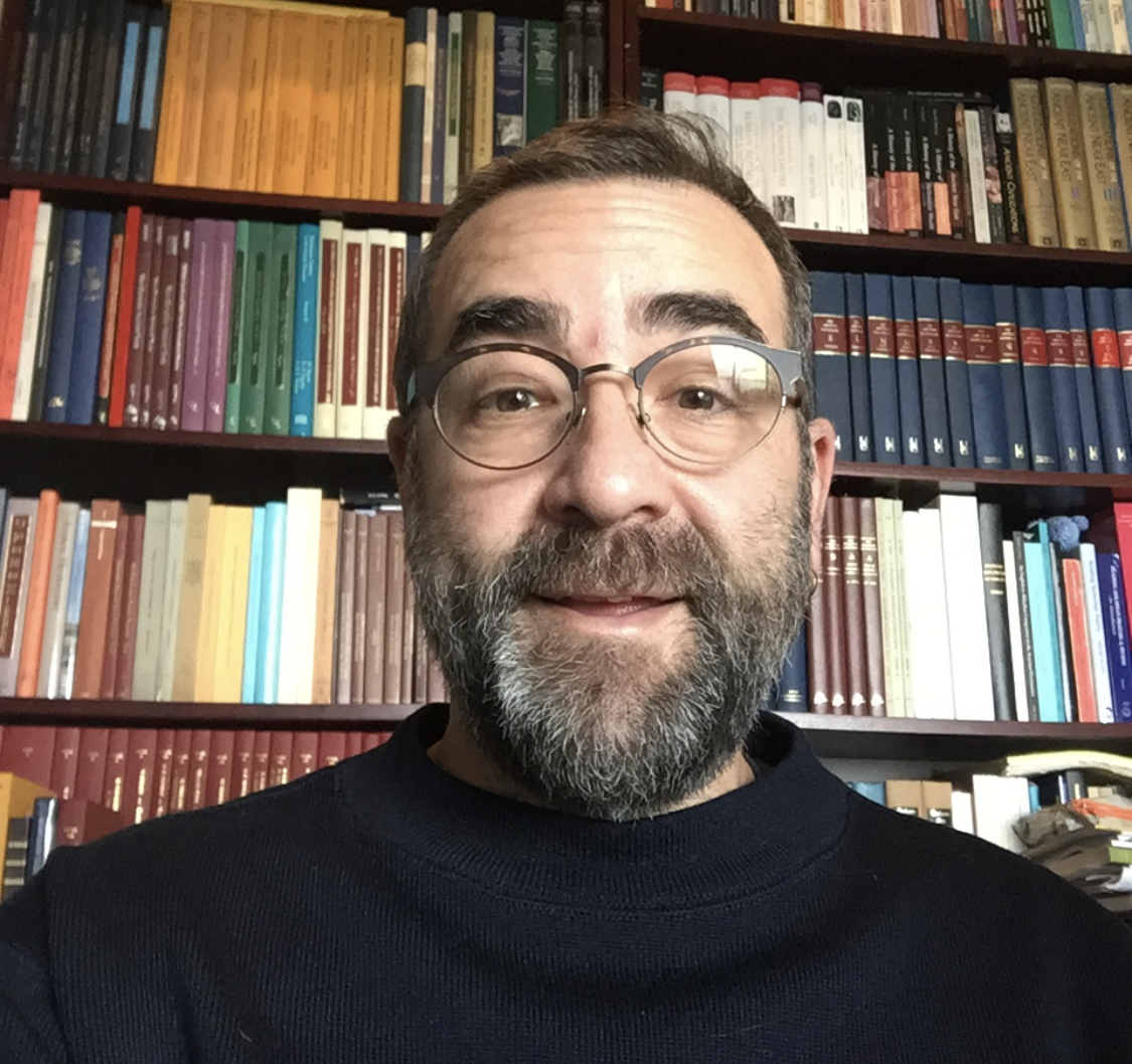 Prof. Garfinkle in front of a full bookshelf
