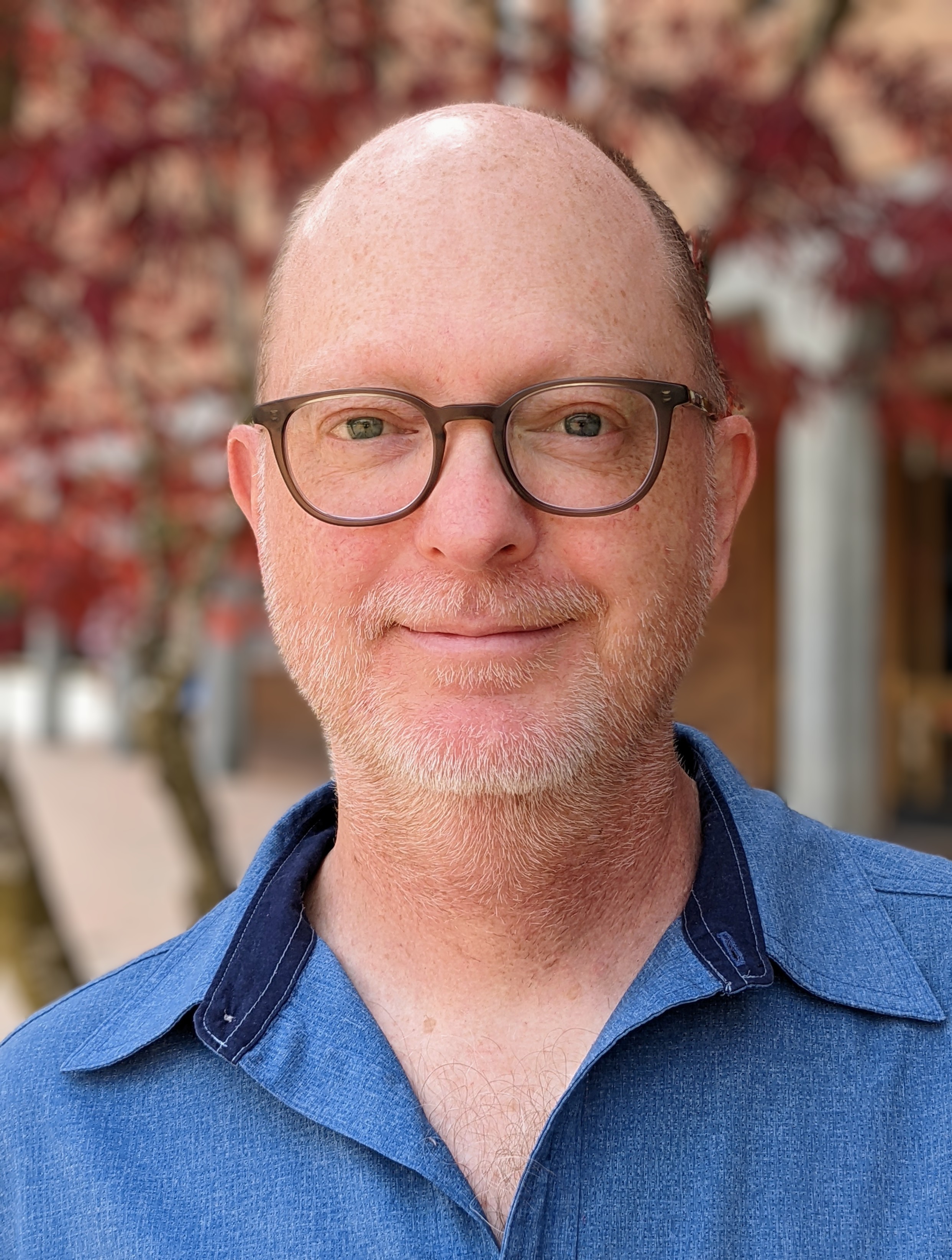 portrait of Jeff Grimm with glasses on, wearing blue shirt