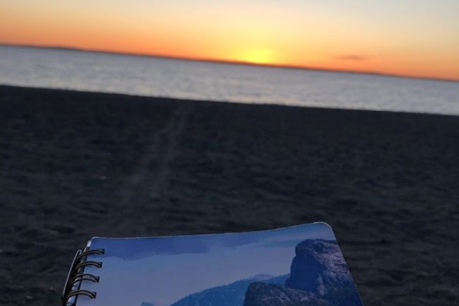 Notebook on beach with sunset