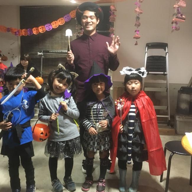 Six Japanese elementary students and preschoolers celebrating Halloween for the first time with help from Martinez, who volunteers at an English Conversation School in Japan.