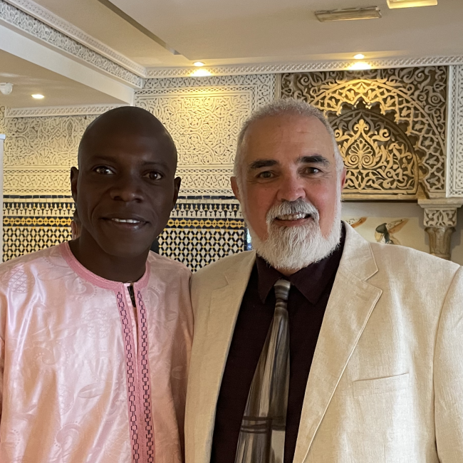 Christopher Wise stands with Amibibé Ouologuem at a conference in Rabat, Morocco