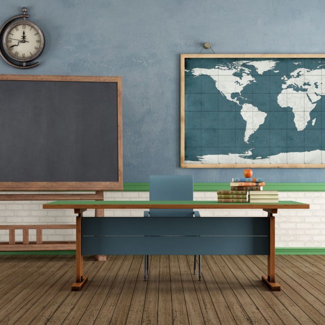 Classroom with a blackboard, world map, and teacher's desk