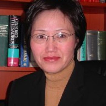 Janet Xing standing in front of a bookcase