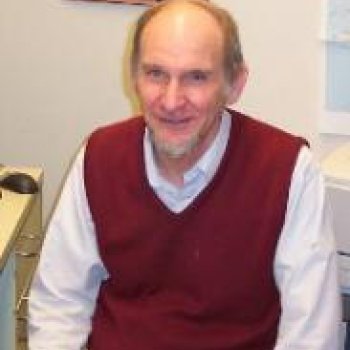 Prof. Patrick Buckley wearing a red sweatervest. 