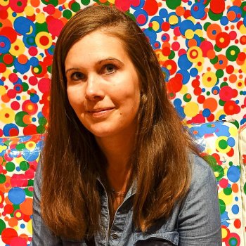 Prof. Lynn against a multi-colored polka dot background