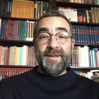 Prof. Garfinkle in front of a full bookshelf