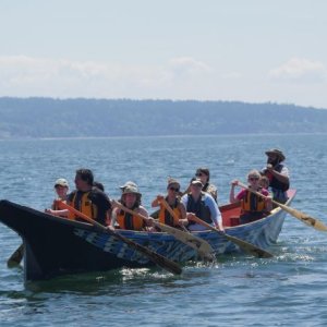 students rowing in canoe journey during field school