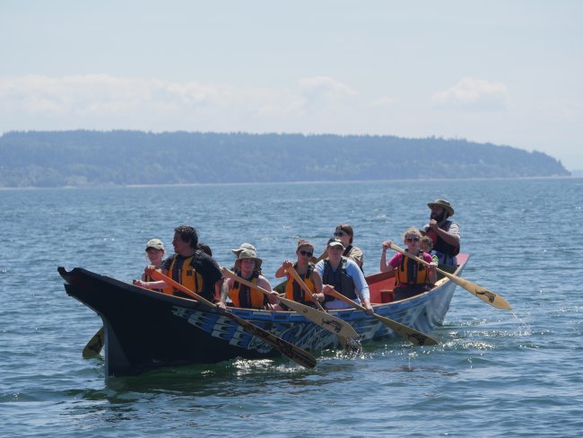 students rowing in canoe journey during field school