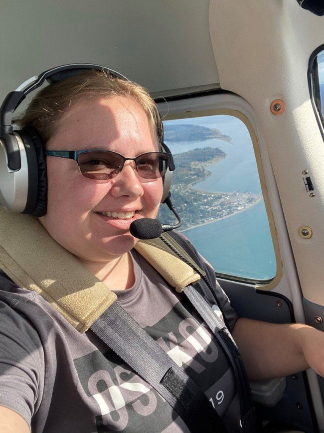 selfie of Elizabeth piloting a small plane