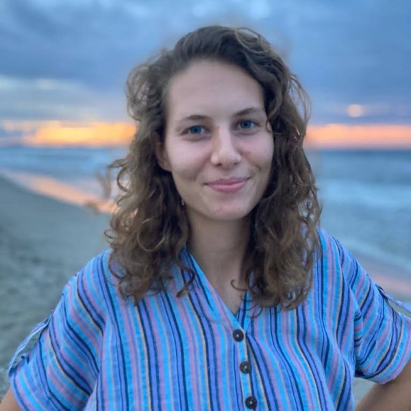 Emily Hillman posing at sunset on a beach.