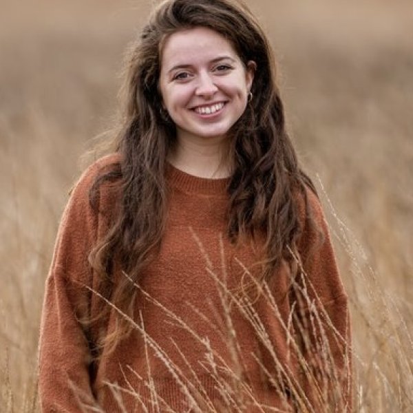 Eliza in a field of long brown grass