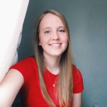 Kimberly Christensen taking a selfie in a bright red t-shirt